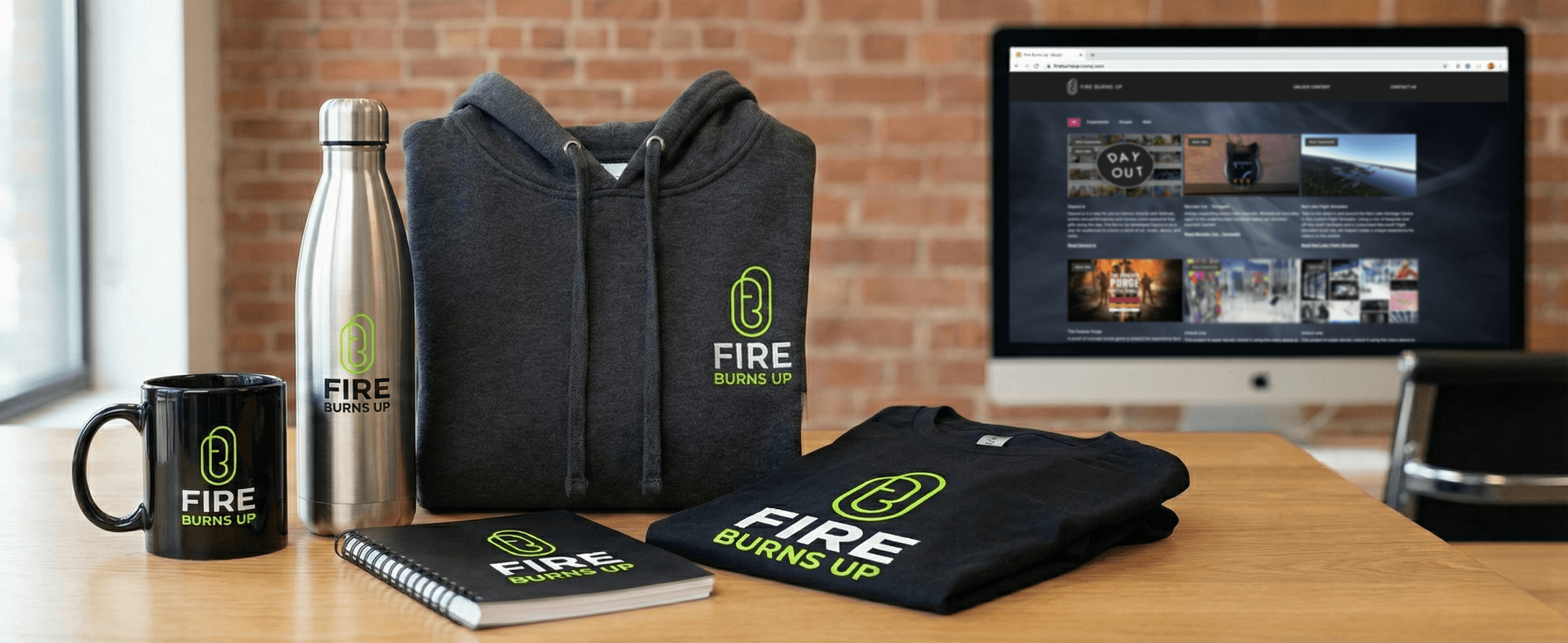 Fire Burns Up branded corporate swag collection featuring hoodie, t-shirt, water bottle, mug, and notebook